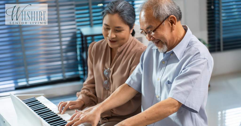 An asian senior elderly couple play the piano together. Music therapy for dementia.
