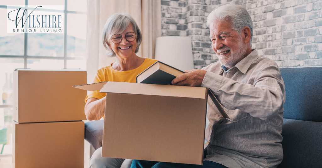 Senior memory care. A husband and a wife are packing things into the boxes.